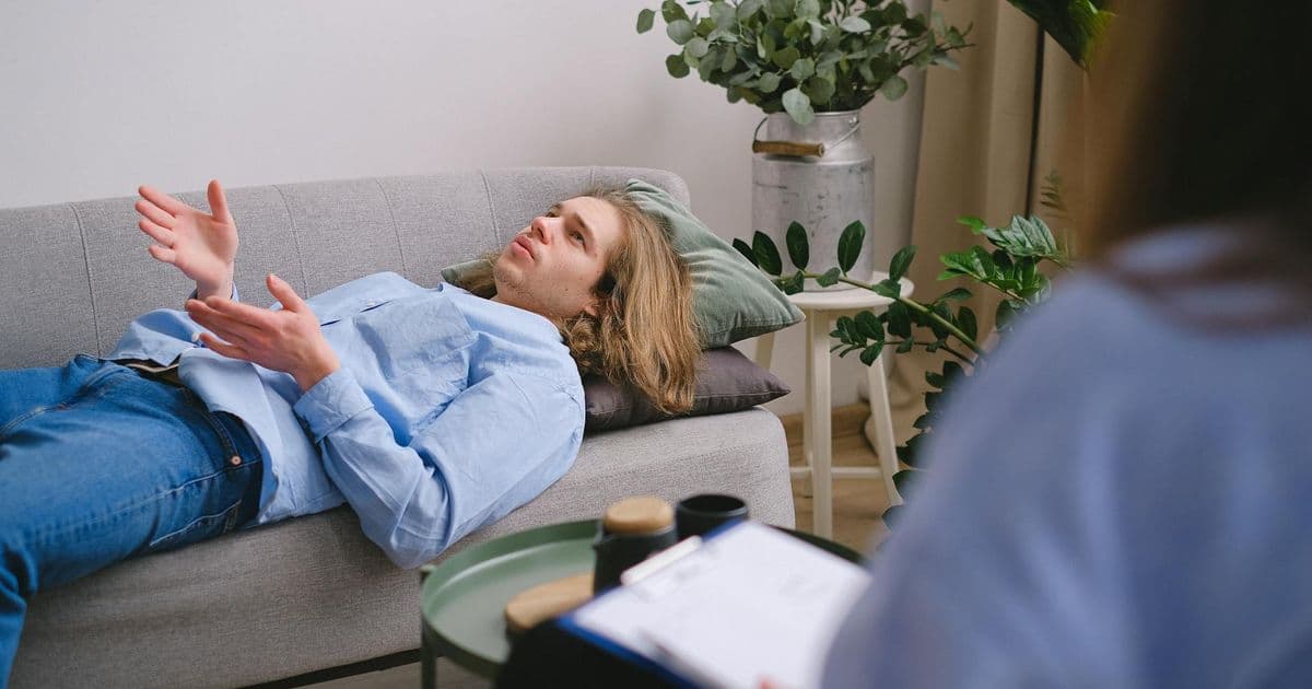 Cognitive behavioral therapy session with therapist writing notes