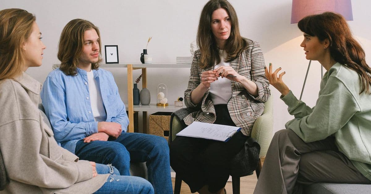 Therapy support group session with multiple participants