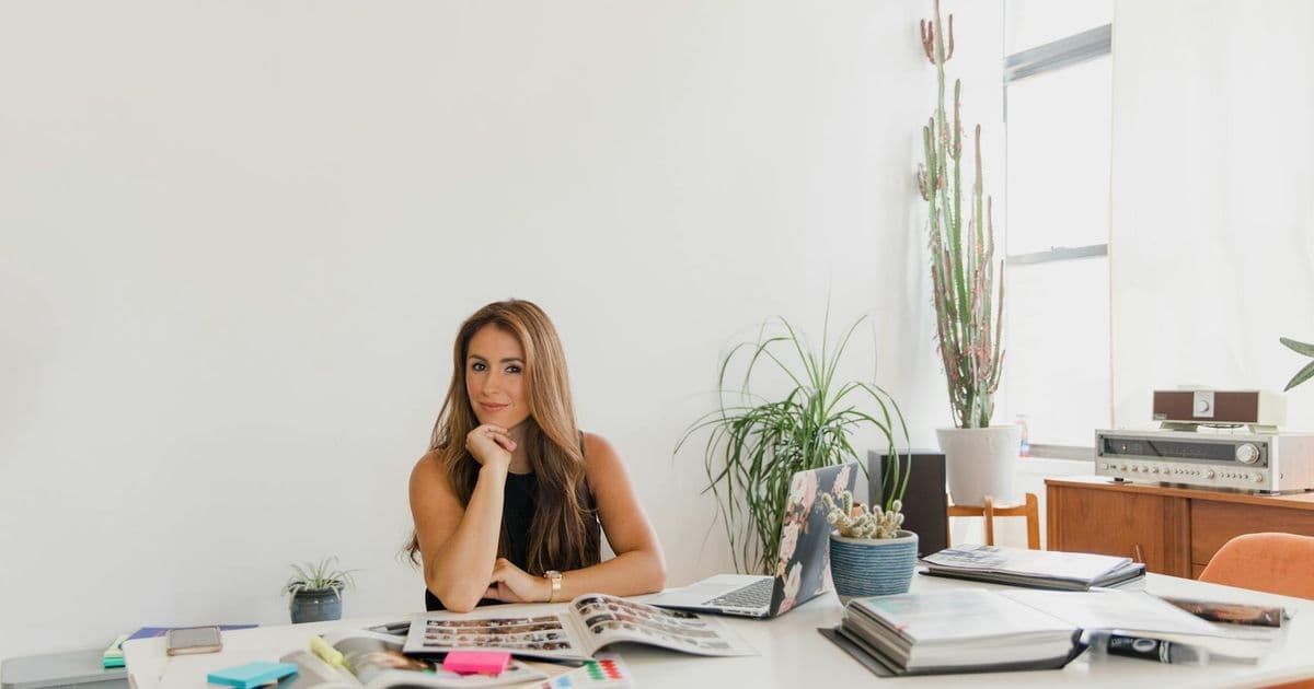 Small business owner at an office desk reviewing financials