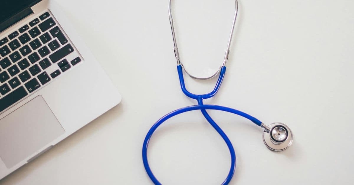 Healthcare professional at a computer comparing billing documents